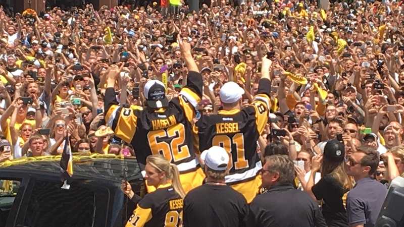 Carl Hagelin and Phil Kessel wave to the huge crowd of fans at the Penguins' Stanley Cup parade.